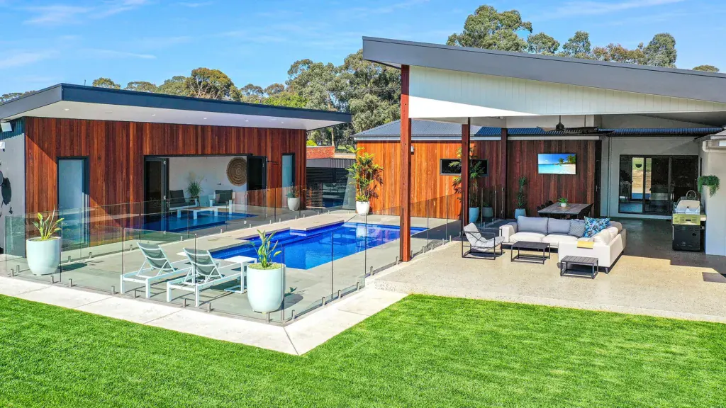 Contemporary fibreglass swimming pool in a landscaped backyard