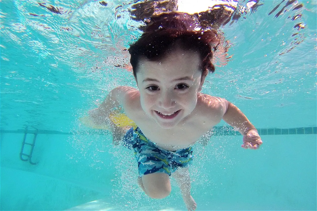 Family enjoying clear, soft pool water